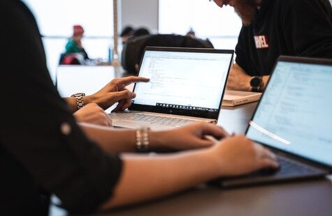 Two persons at laptops