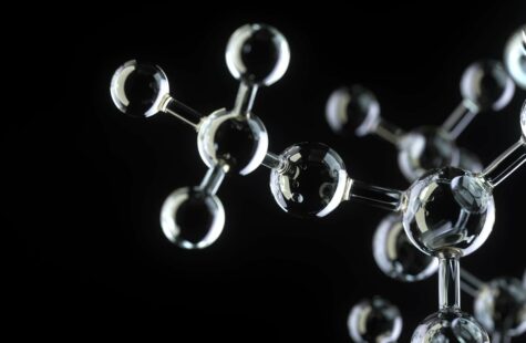 Molekyler i glas mot svart bakgrund